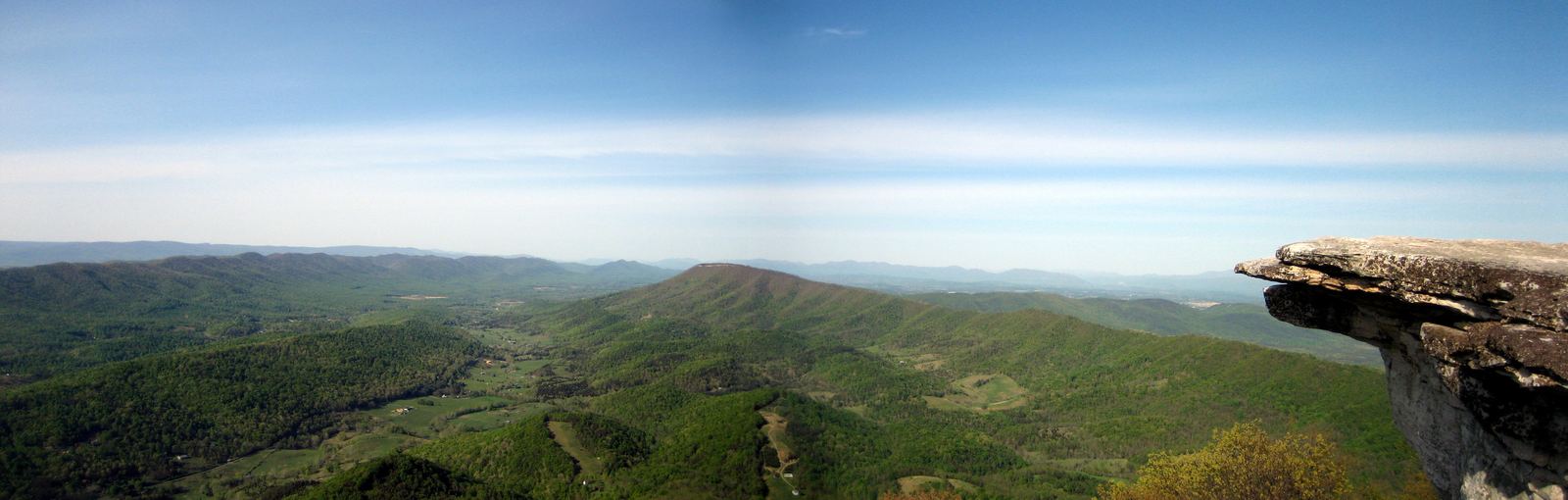Panoramic view from the rock ledge of McAfee Knob over forested Virginia ridges