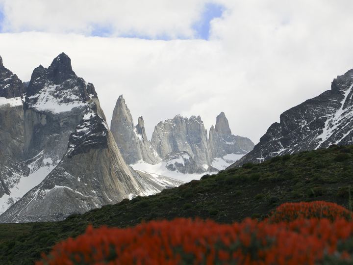 The dark-capped Cuernos del Paine peaks and granite towers above a blue lake